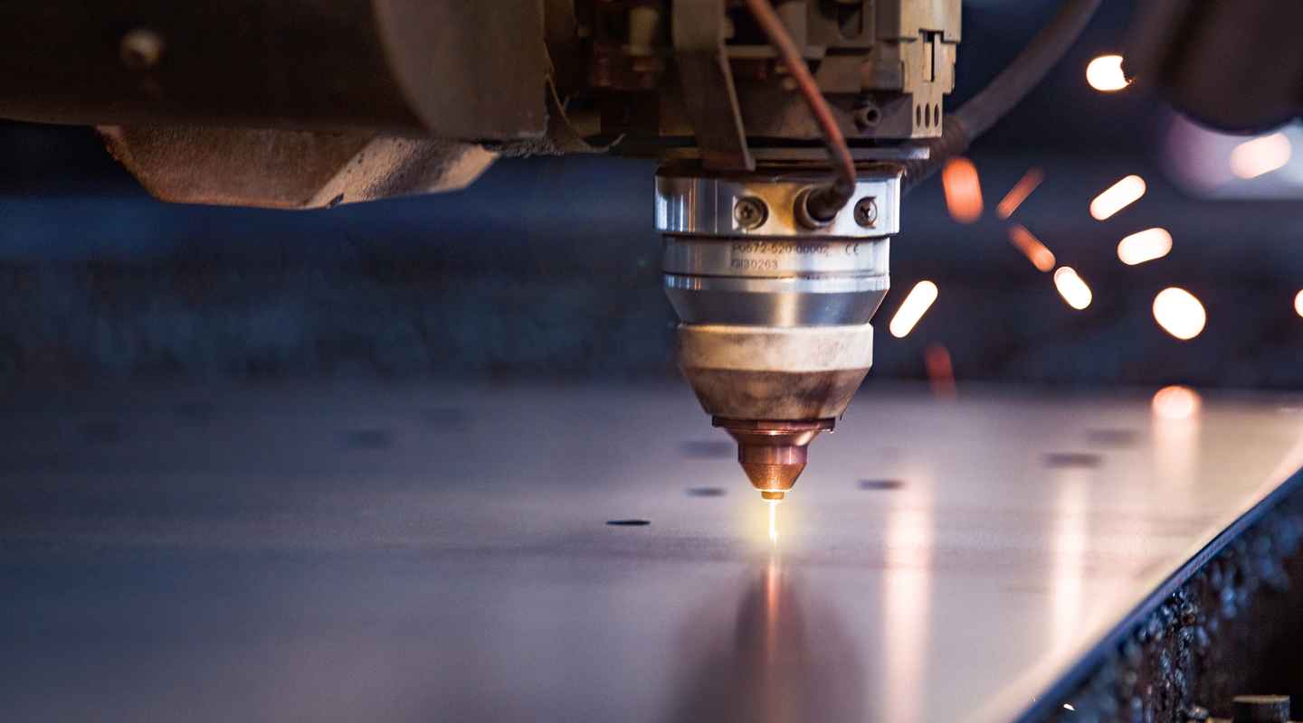 Close up of a laser cutting machine starting to pierce a metal plate